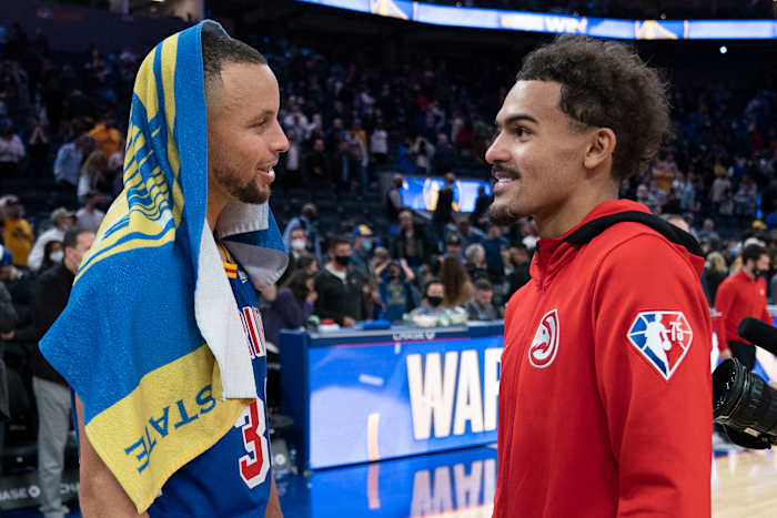 Golden State Warriors guard Stephen Curry and Atlanta Hawks guard Trae Young talk after the game.